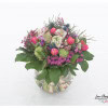 Spring bouquet with ranunculus, tulips, viburnum, hyacinths, thistles, anemones, Christmas roses, wax flowers and blueberries