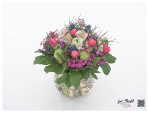 Spring bouquet with ranunculus, tulips, viburnum, hyacinths, thistles, anemones, Christmas roses, wax flowers and blueberries