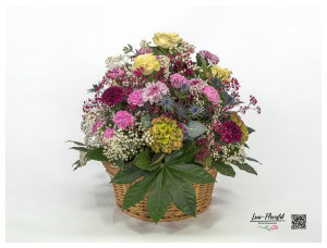 Flower basket with roses, hydrangeas, gypsophila, thistles, chrysanthemums and carnations