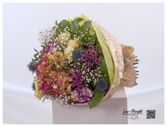 Bouquet of flowers with carnations, hydrangea, chrysanthemums, thistle, roses and gypsophila for a birthday