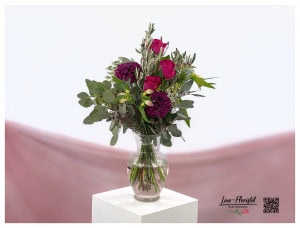 Bouquet with pink chrysanthemums, red roses, lilies, wax flowers and eucalyptus