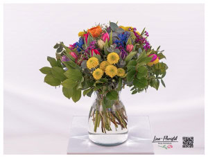 First spring bouquet with colorful tulips, santini, hyacinths, wax flowers, eucalyptus and gypsophila