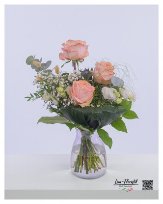Bouquet with peach pink roses, white lisianthus, eucalyptus, white gypsophila, blue thistles and phalaris.