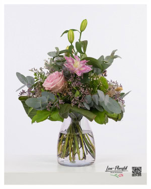 Bouquet with pink lilies, pink roses, purple sea lavender, eucalyptus, green bearded carnations and phalaris