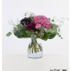 This elegant bouquet combines the dramatic beauty of black roses with the vibrant color of a pink hydrangea, complemented by the delicate green of eucalyptus, the velvety texture of celosia, the delicate accents of sea lavender and the playful flowers of carnations.