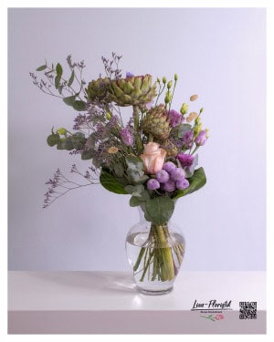 Tiered bouquet with artichokes, pink rose, purple lisianthus, statice, purple santini and eucalyptus