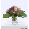 Gentle summer bouquet with hydrangeas, artichokes, pink roses, red gypsophila and lisianthus in pastel