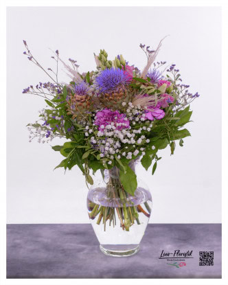 Summer bouquet with artichokes, carnations, thistles, lisianthus, statice, gypsophila and pampas grass