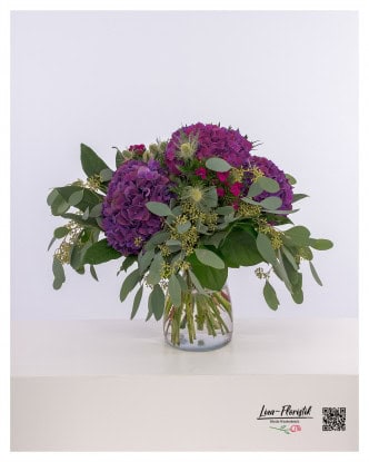 Magnificent bouquet of purple hydrangeas, red carnations and thistles, elegantly combined with fresh eucalyptus.