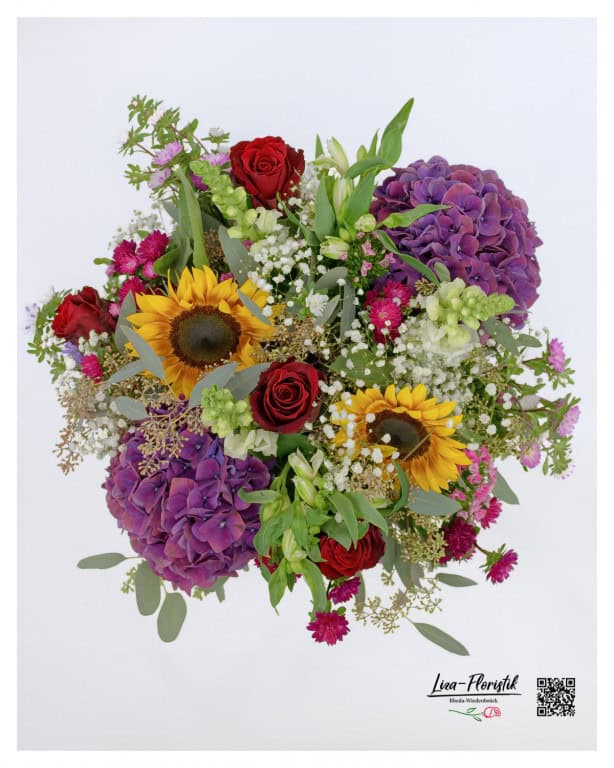 An impressive top view of the voluminous bouquet, which is magnificently arranged with bright sunflowers, purple hydrangeas, red roses, carnations, snapdragons, eucalyptus, asters and delicate gypsophila.