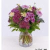Colorful chrysanthemum bouquet with chamomile and sedum, artfully tied in delicate pink and cream tones