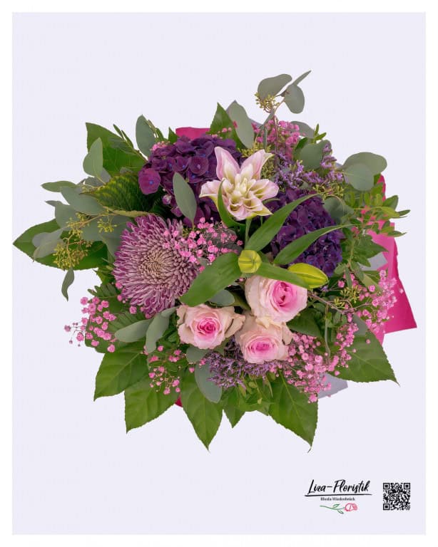 Bouquet of flowers with lilies, roses, hydrangeas, eucalyptus and pink gypsophila for a birthday from a bird's eye view
