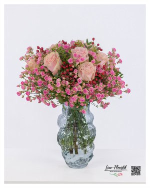 Delicate bouquet of pink roses, playful polyanthar roses and bright hypericum - a harmonious composition full of elegance.