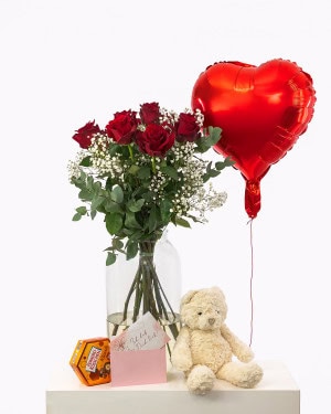 A sign of affection: 10 deep red premium roses, a cuddly soft teddy bear, sweet Ferrero kisses, a heart balloon and your personal message - everything to give a special person a smile.