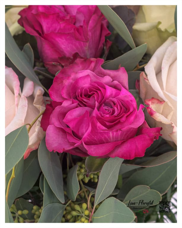 Detailed shot of an Ecuador rose - Close-up of a magnificent Ecuador rose in intense pink tones, framed by delicate eucalyptus green. The fine structure and color intensity of the petals make this rose a real eye-catcher and add that certain something to any arrangement.
