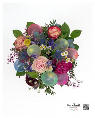 The birthday bouquet with roses, thistles, clematis, eucalyptus and chamomile in top view