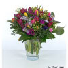 A lively spring bouquet with a harmonious mix of red, yellow and pink tulips, delicate gypsophila flowers, violet statice, bright lady's mantle and lush green eucalyptus - a colorful arrangement full of freshness and joy of life.