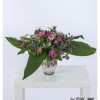 Elegant bouquet with French tulips, carnations, polyantha roses, eucalyptus and olive branches - stylish floristry in purple and green for special occasions.