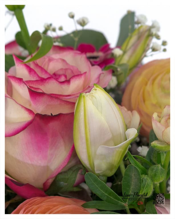 Fresh lily bud as a detail in Mother's Day bouquet with roses and ranunculus