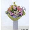 Happy birthday bouquet with pink lilies, delicate roses, purple chrysanthemums, gypsophila and colored statice - lovingly tied and wrapped with a decorative green-purple paper cuff, perfect as a flowery birthday greeting.