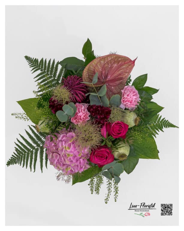 Modern bouquet of flowers in rich pink and pink tones with anthurium, hydrangeas, roses, carnations, poppy capsules, red ammi and eucalyptus - expressive top view with fine green tones.