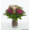 Bouquet with pink hydrangeas, soft pink Ecuador roses of the Pink Mondial variety, colored Ami, purple statice and airy wig bush, surrounded by strong green.