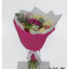 Bouquet with mixed roses, carnations, lisianthus, chamomile and eucalyptus, decoratively tied and arranged in a pink cuff.