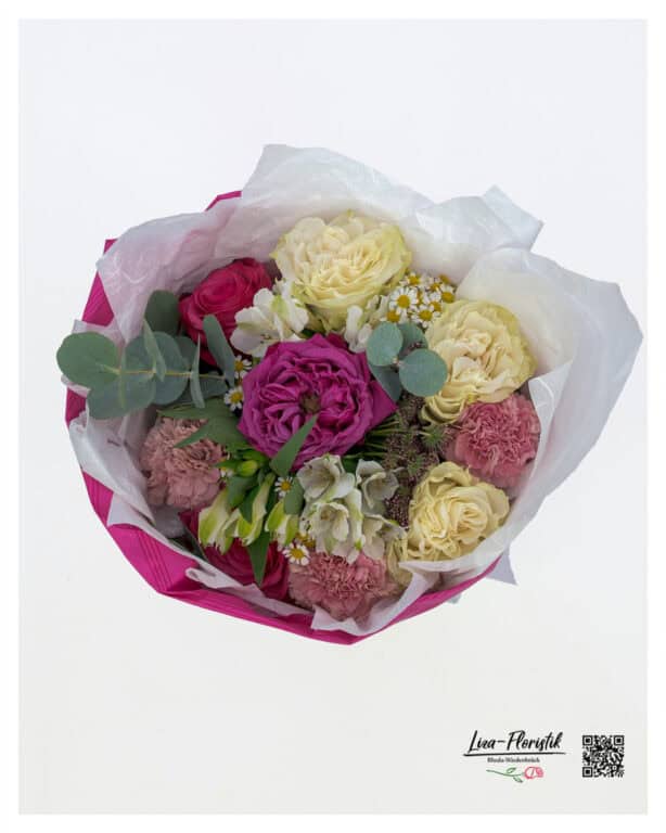 Top view: Bouquet of cream and pink roses, carnations, lisianthus, chamomile and eucalyptus, decoratively tied in a pink cuff.