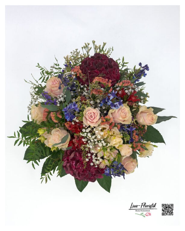 Large bouquet of flowers in detail with roses, hydrangeas, gypsophila, lisianthus, statize, larkspur and alstromeria