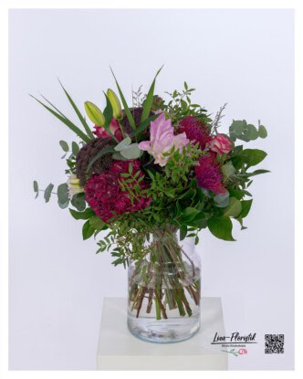 Opulent bouquet of flowers with roses, celosias, angelica giga, pincushion protea, lilies and eucalyptus - elegantly tied in harmonious colors.