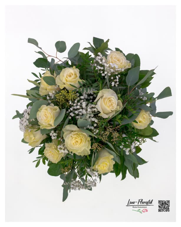 The bouquet photographed from above in delicate cream and green tones, harmoniously tied in a round shape and freshly arranged.