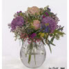 Impressive bouquet of flowers with roses, purple hydrangeas, airy gypsophila, eucalyptus, statice, thistles and bright delphiniums.