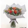 Apricot bouquet with roses and lisianthus in a warm coral tone, embedded in eucalyptus and gypsophila