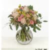 Delicate bouquet of flowers in pastel tones, harmoniously tied in a round shape, with a gentle, romantic look.