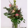 Expressive flower bouquet with pink roses, protea and amaryllis in warm autumn ambiance