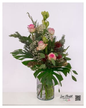 Expressive flower bouquet with pink roses, protea and amaryllis in warm autumn ambiance