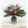 Lavish bouquet with pink roses, white amaryllis, monstera leaves, olive branches and lilac sea lavender