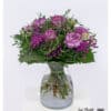 Romantic bouquet with purple roses, carnations, baby's breath and chamomile in various violet tones
