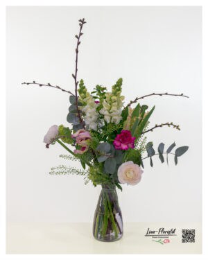 An Easter bouquet featuring parrot tulips combines wild beauty with Easter joy. Parrot tulips, carnations, cherry branches, and ranunculus are arranged harmoniously.