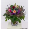 Creatively tied bouquet with colorful premium roses and clematis – featuring snapdragons, statice, thistles, and decorative woven accents.