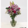 Bouquet with lilies and roses combines fresh chamomile and delicate sea lavender into a harmonious, colorful arrangement.
