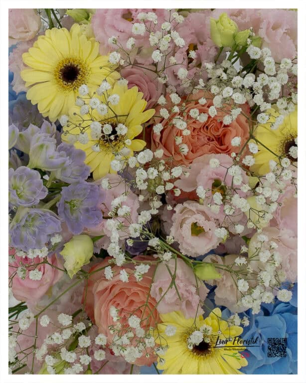 close-up of a pastel-colored bouquet with yellow gerberas, pink and apricot roses, lisianthus, light blue hydrangea, delphiniums and baby's breath