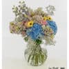 large bouquet in pastel with blue hydrangeas, yellow gerberas, pink roses and delphiniums