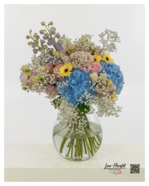 large bouquet in pastel with blue hydrangeas, yellow gerberas, pink roses and delphiniums